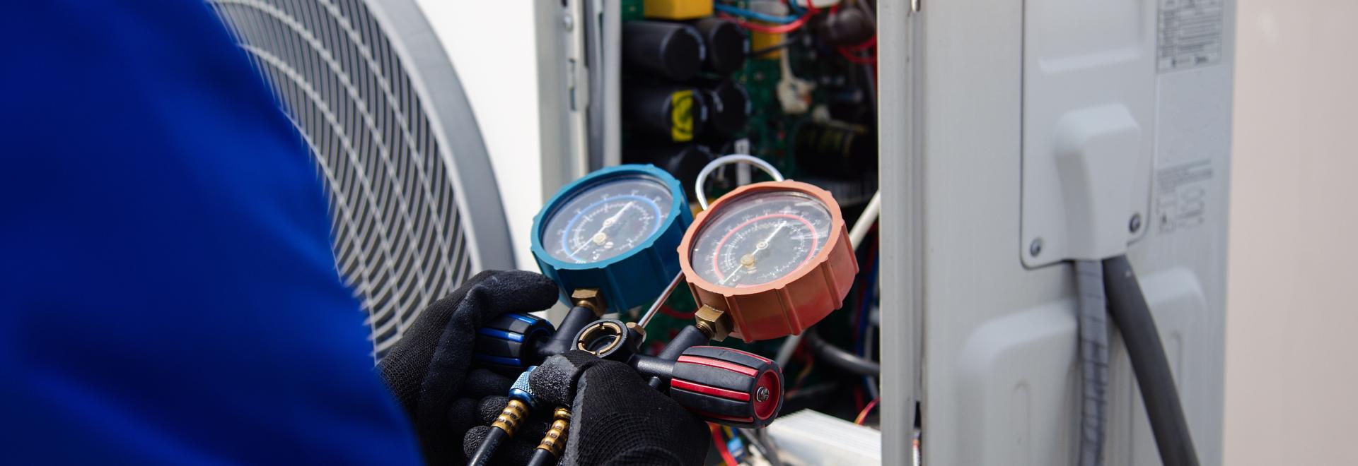 man working on a heat pump air conditioner